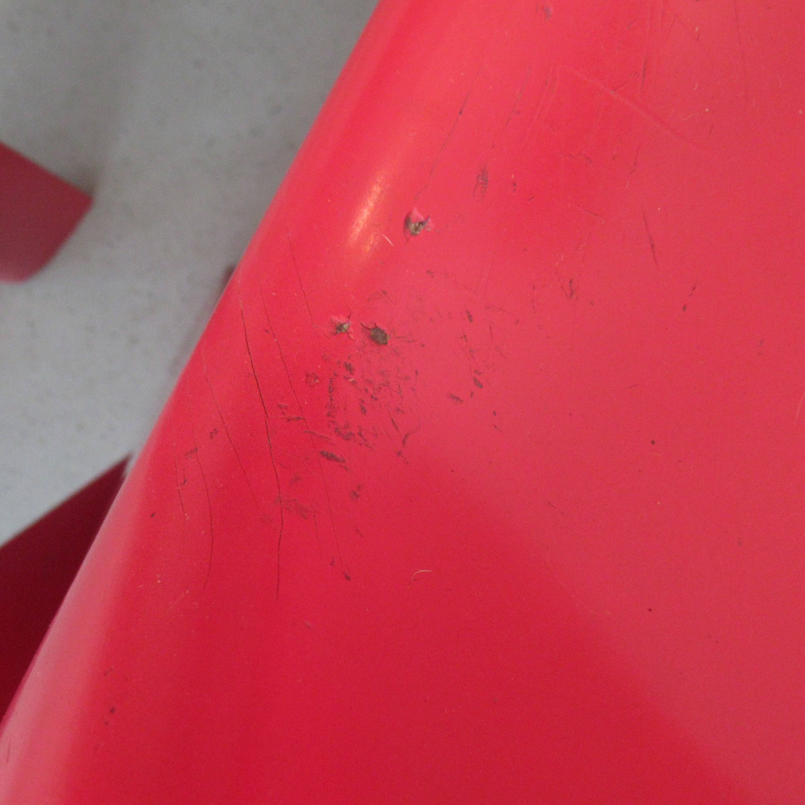 Four red fibreglass chairs from the 1970s.