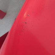 Four red fibreglass chairs from the 1970s.