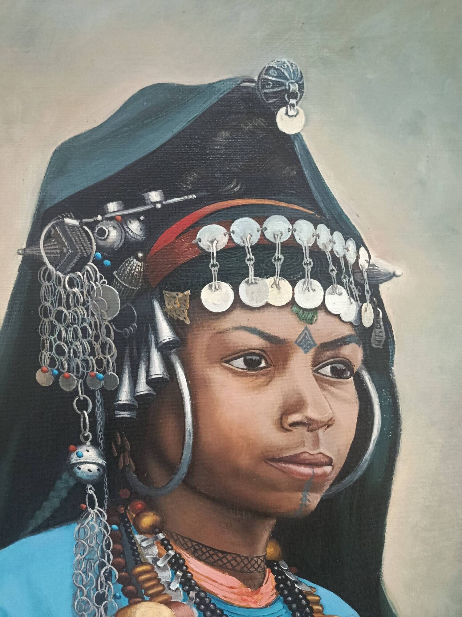Portrait of a young Moroccan woman in traditional attire and adornments.