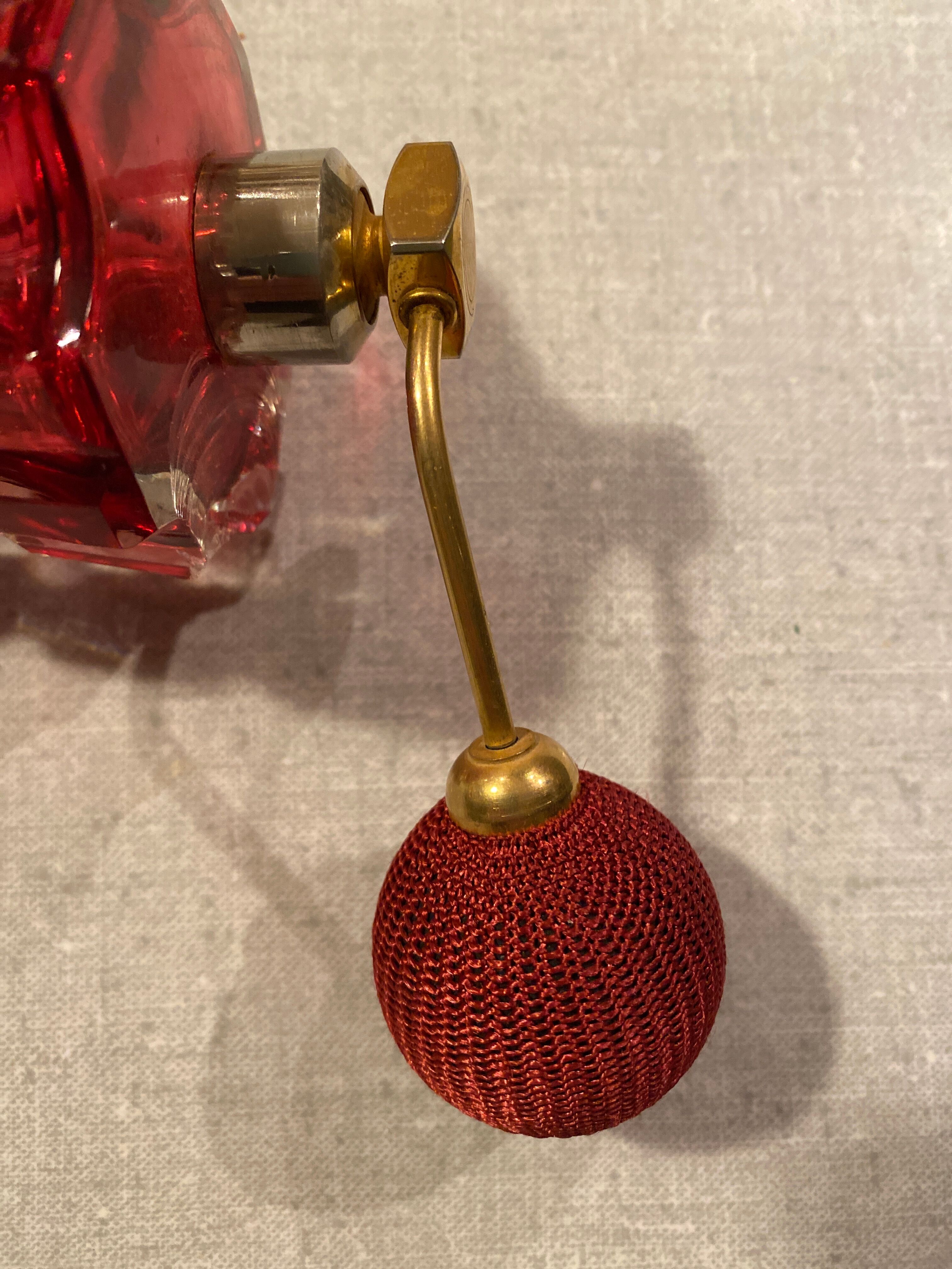 Red crystal perfume spray and red pump.