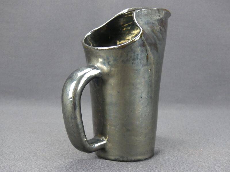 Old Biot, modernist pitcher in iridescent black ceramic.