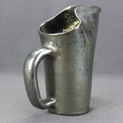 Old Biot, modernist pitcher in iridescent black ceramic.