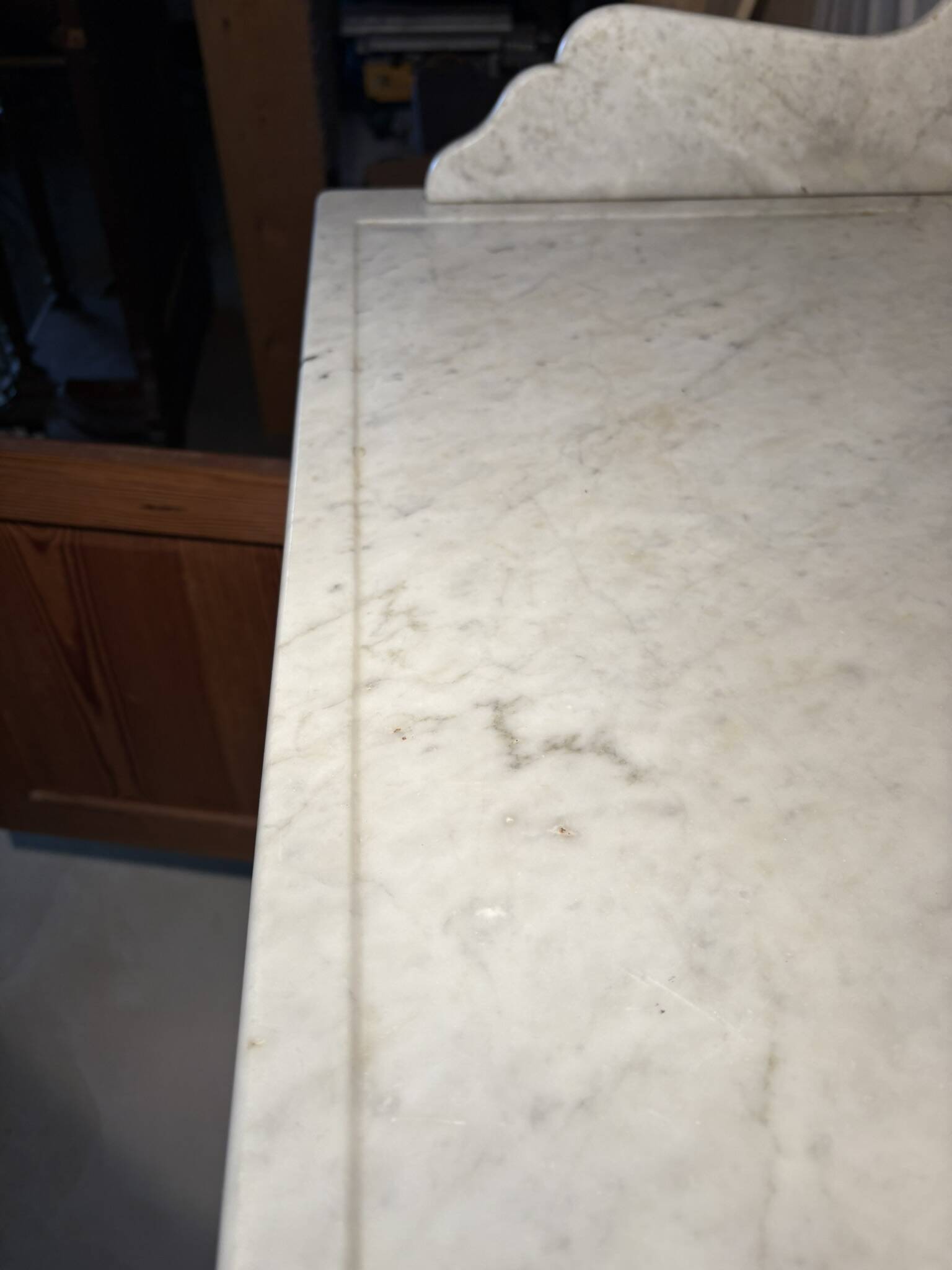 Antique wood and marble kitchen sideboard with carved backsplash