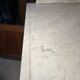 Antique wood and marble kitchen sideboard with carved backsplash