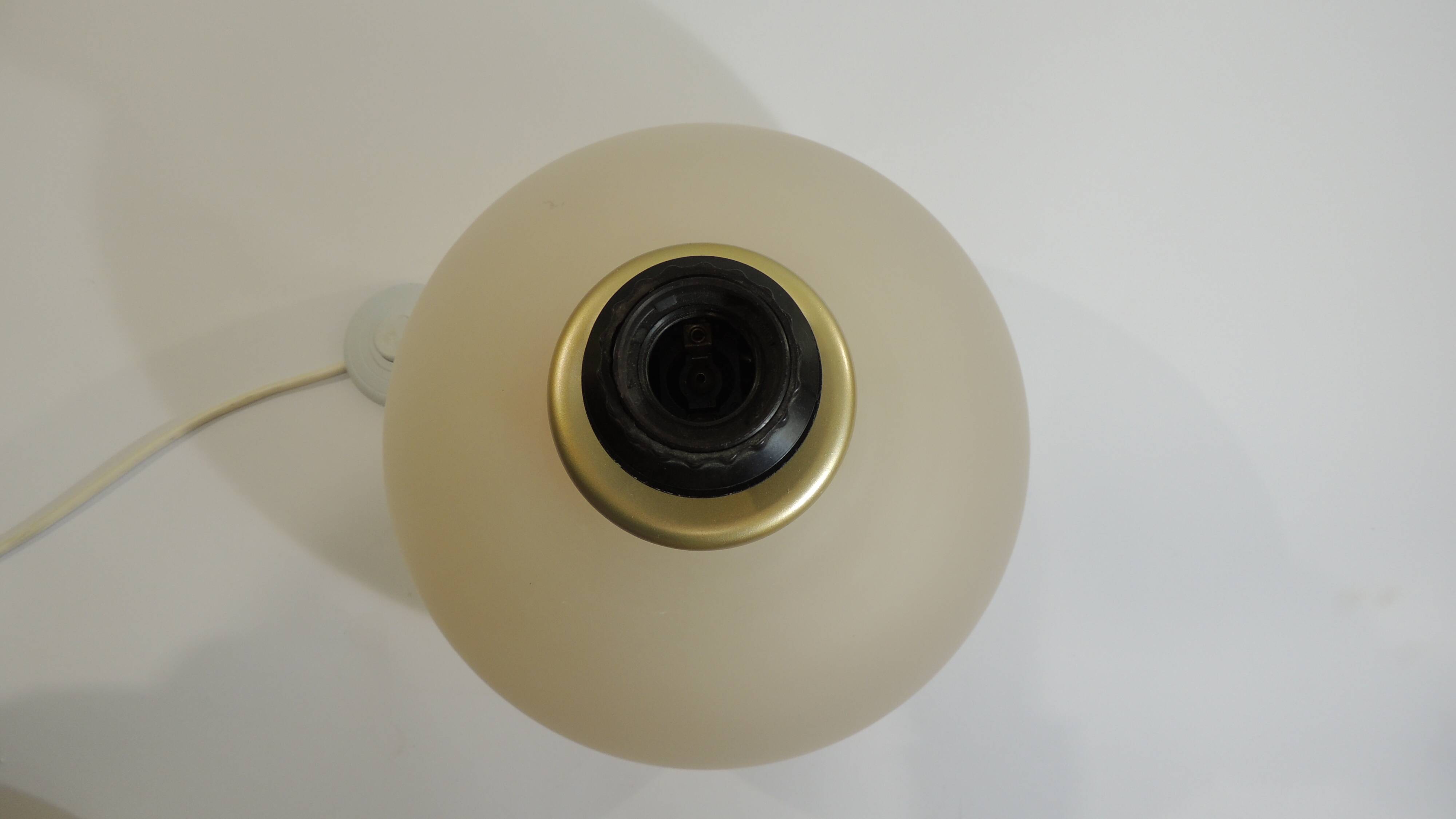 Vintage frosted glass lamp, round globe, elegant design, soft light.