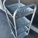Four-wheeled dessert trolley with 4 perforated metal shelves.