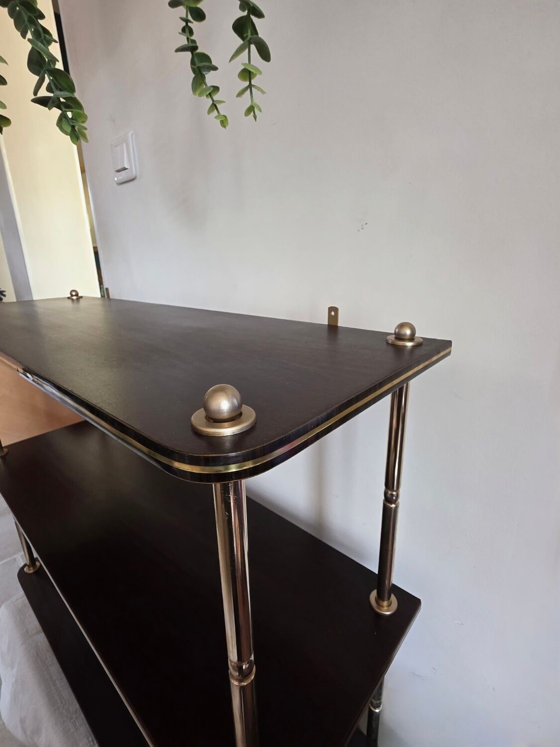 Wooden shelf with gold metal