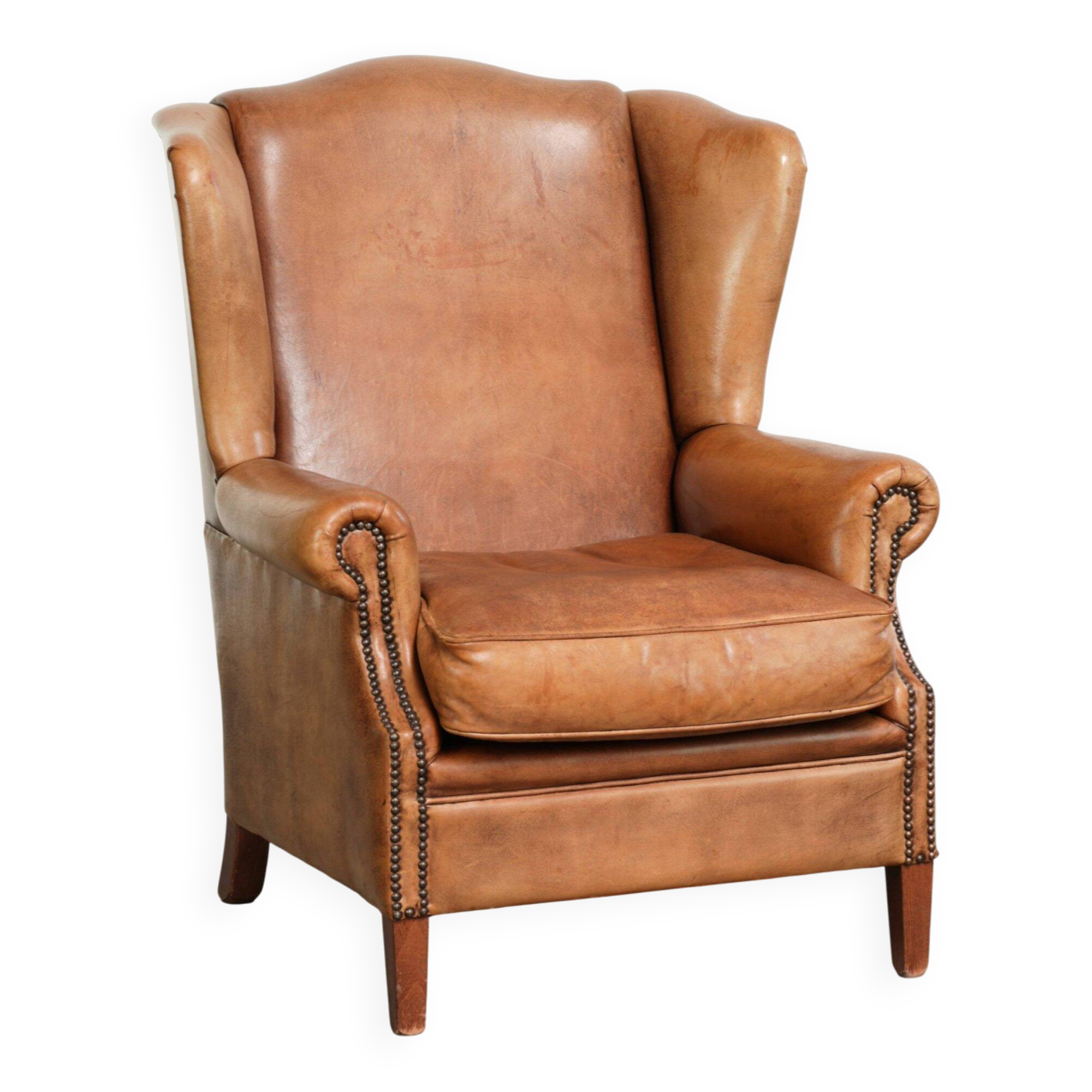 Sheepskin wingback armchair in a light cognac colour in English style