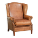 Sheepskin wingback armchair in a light cognac colour in English style