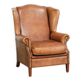 Sheepskin wingback armchair in a light cognac colour in English style