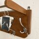 Wall-mounted wardrobe with 4 hooks in wood and aluminum with beveled trapezoid mirror