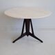 Mid-century modern round dining table in marble and ebony wood.