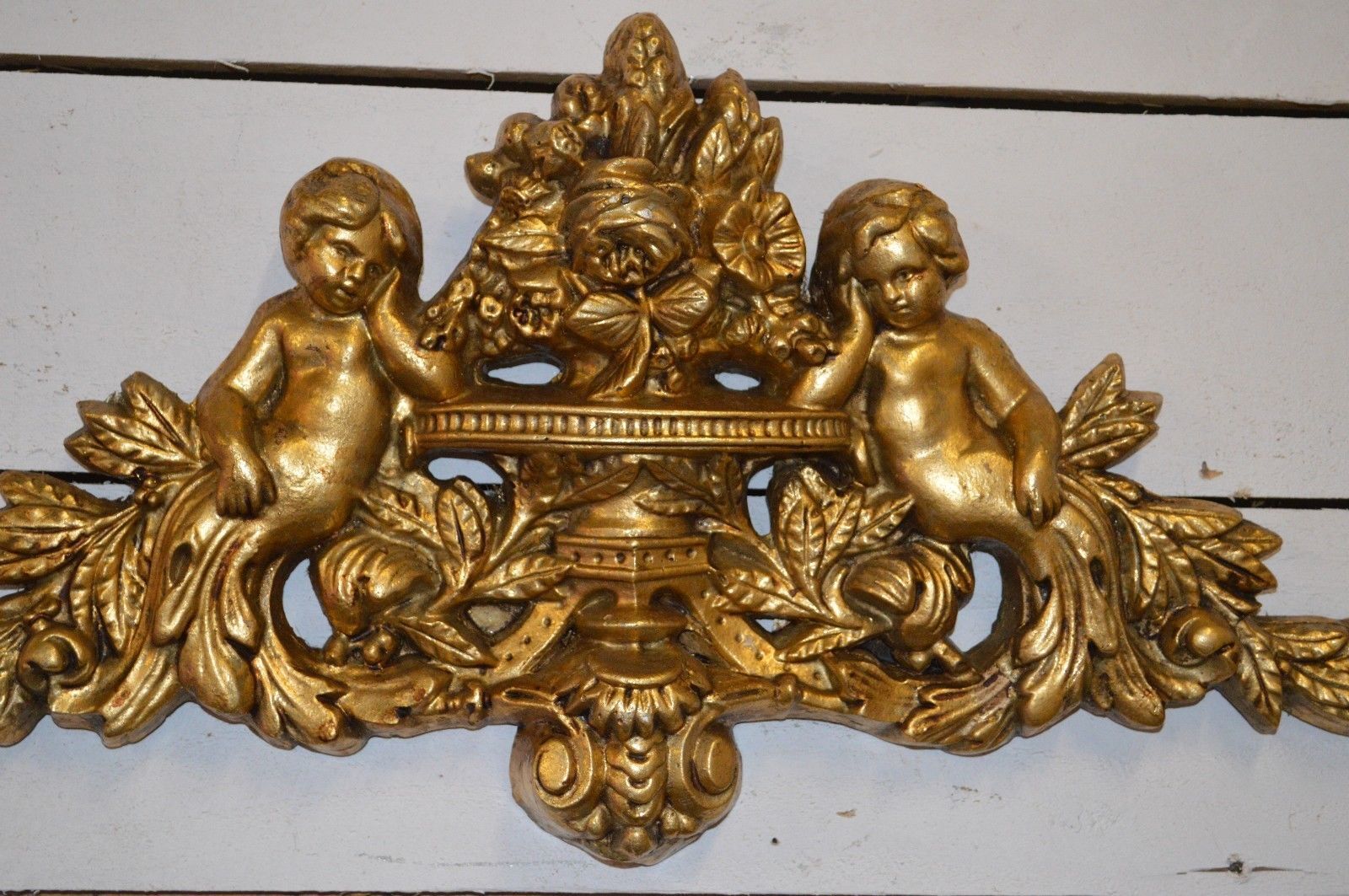 Pediment with patinated characters golden
