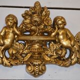 Pediment with patinated characters golden