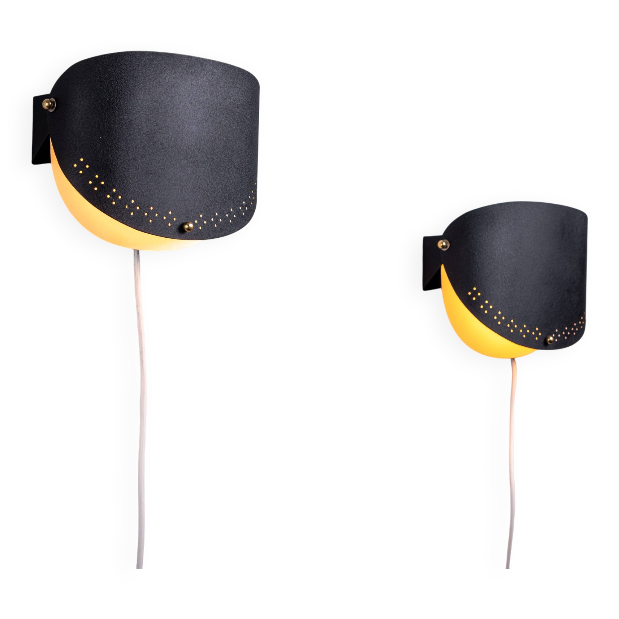 Matte black wall lamps with perforated shades and brass details