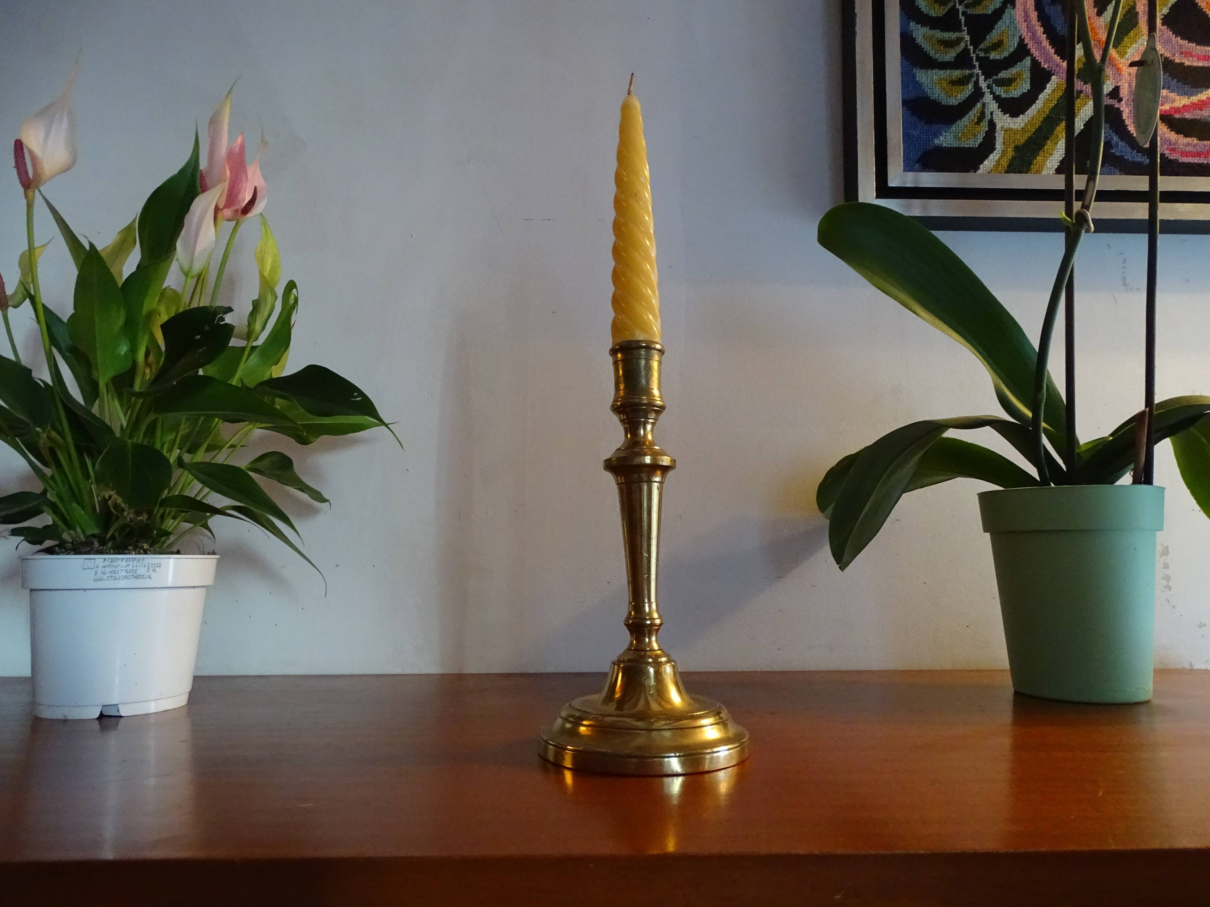 Old brass candle holder and its candle 21.5 cm
