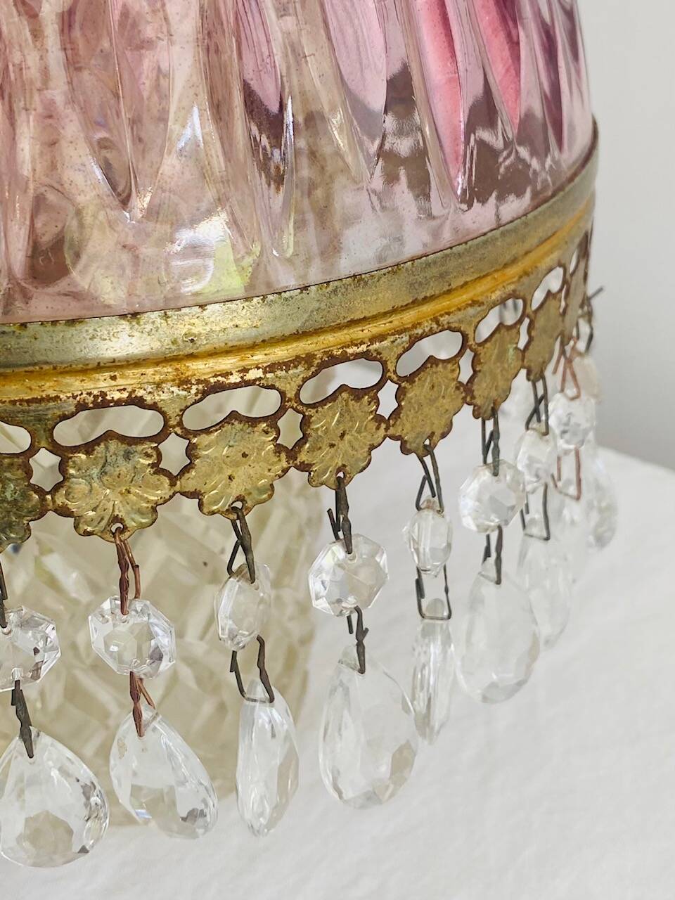 Antique pink glass pendant light with tassels.