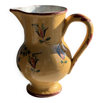 Large antique handmade ochre yellow jug with a pink flower pattern.