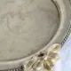 Vintage silver-plated serving tray with bow handles.