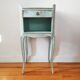 Patinated bedside table end of sofa