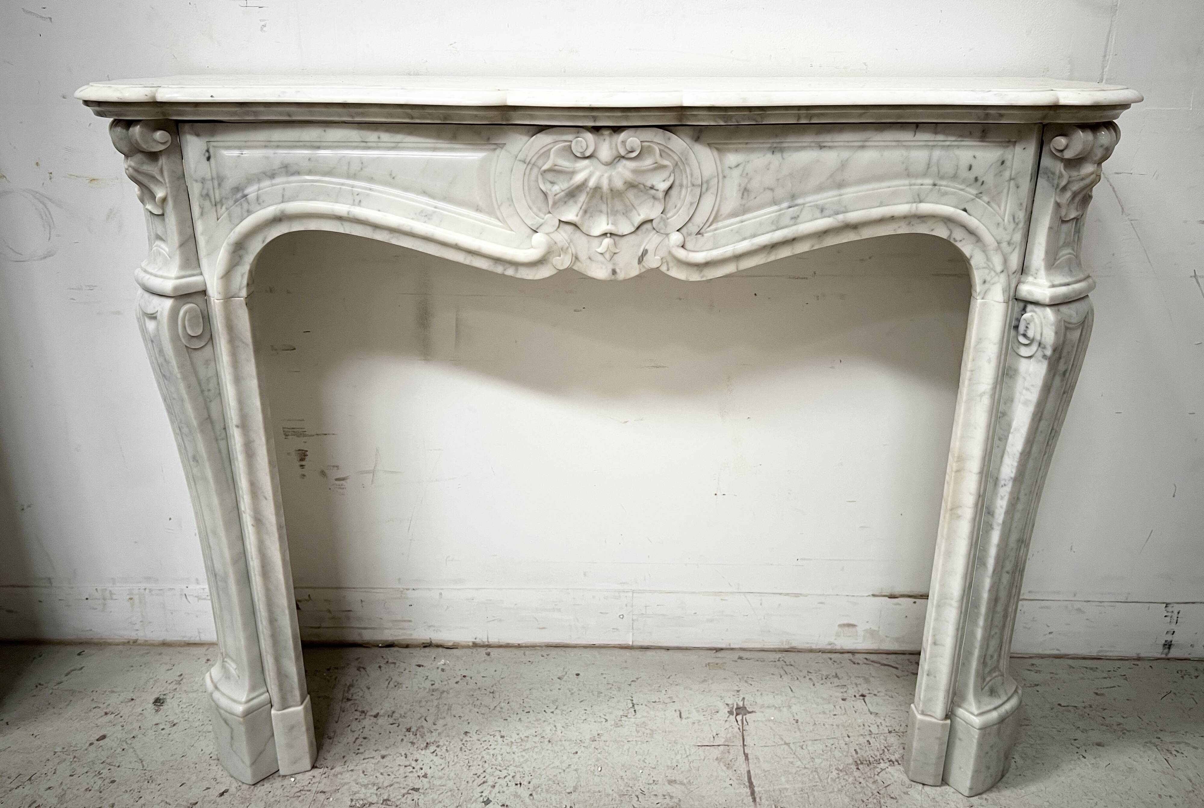 Louis XV style fireplace in veined white marble, 20th century.