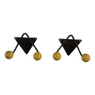 Pair of vintage black wrought iron and yellow wood coat hooks 1950