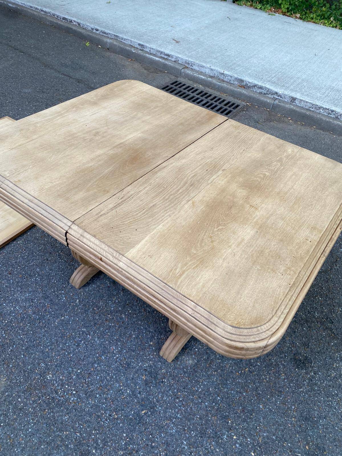 Art Deco dining table with a central pedestal, stripped in solid oak, with 2 extensions.