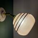 Vintage globe wall light in frosted pink and gold glass.