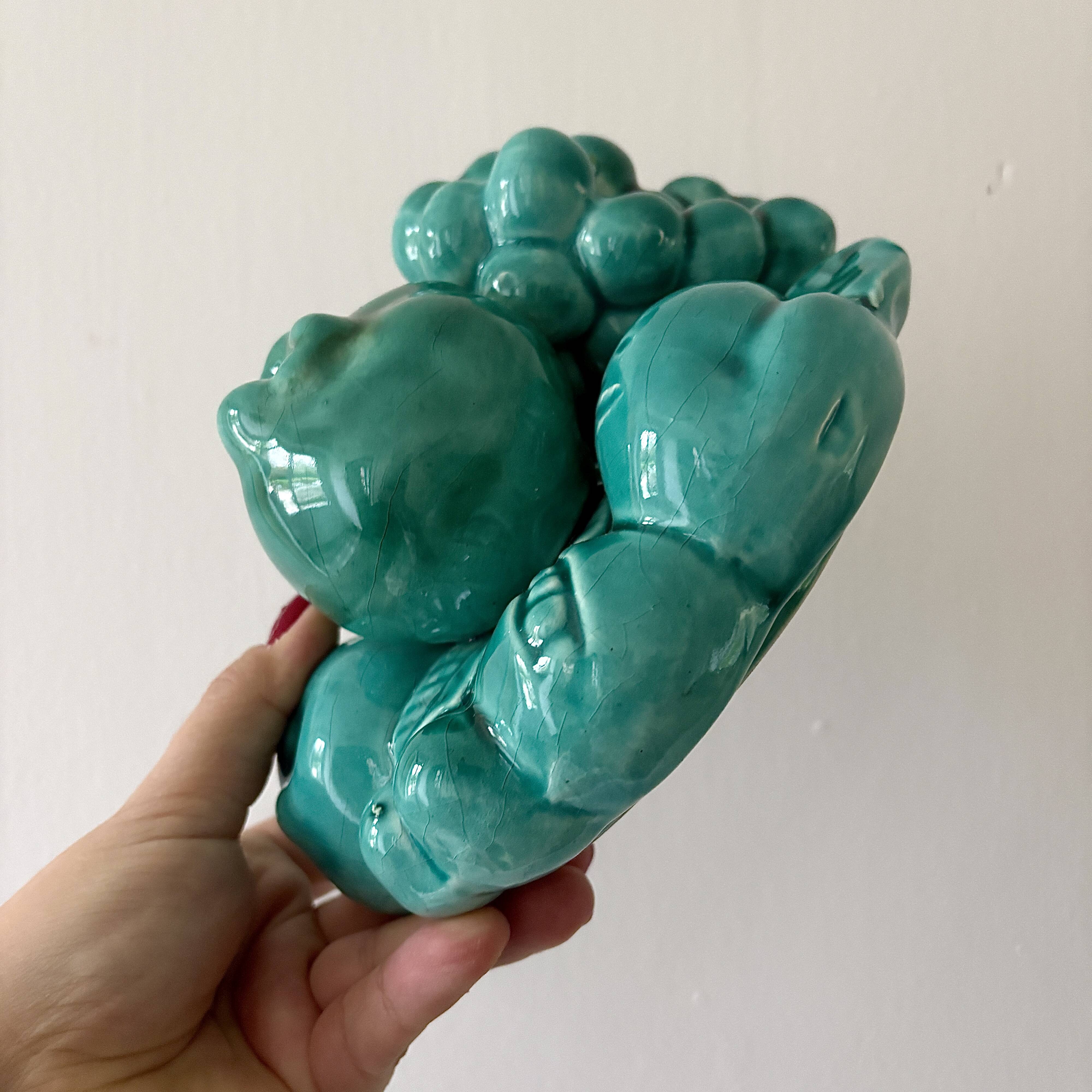 Vintage green earthenware plate/basket with fruit decorations.