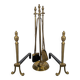 Pair of fire dogs and fireplace tools
