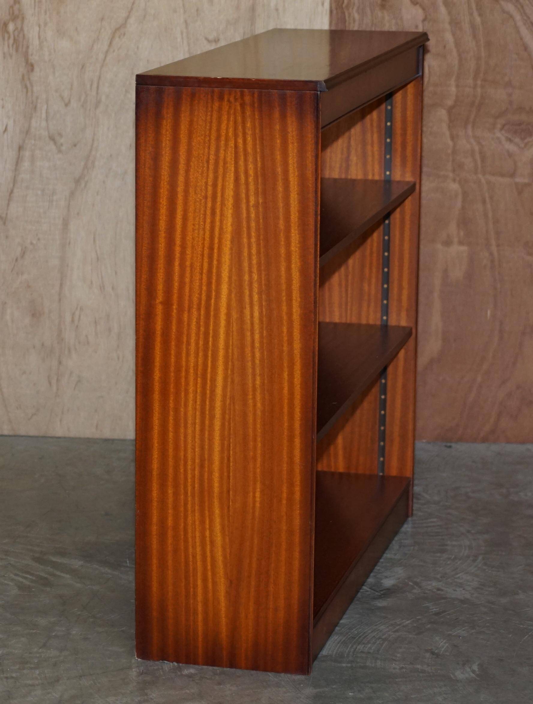 Pair of open dwarf bookshelves in mahogany by Shaws of London.
