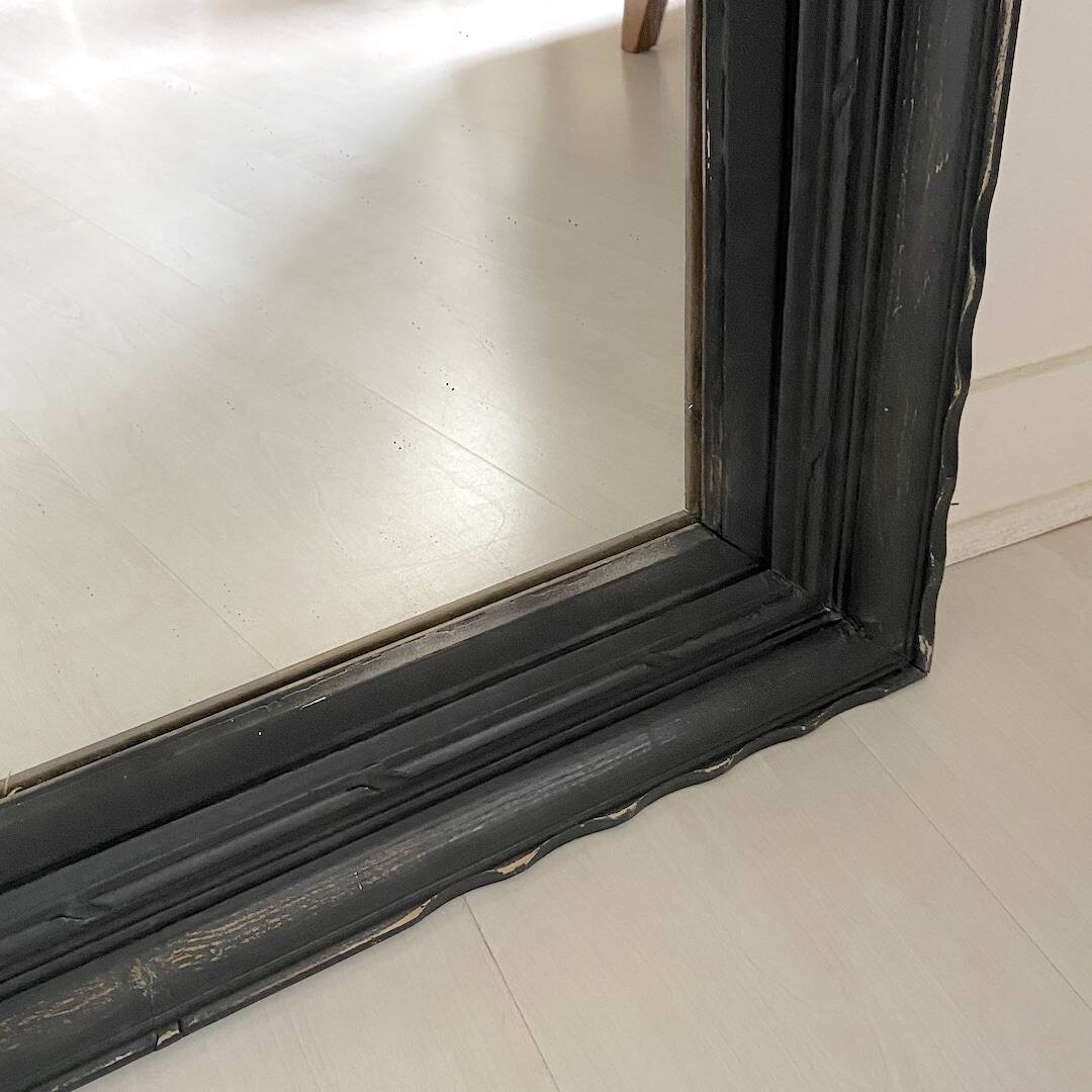 1950s mirror, matte black wood with a patina.