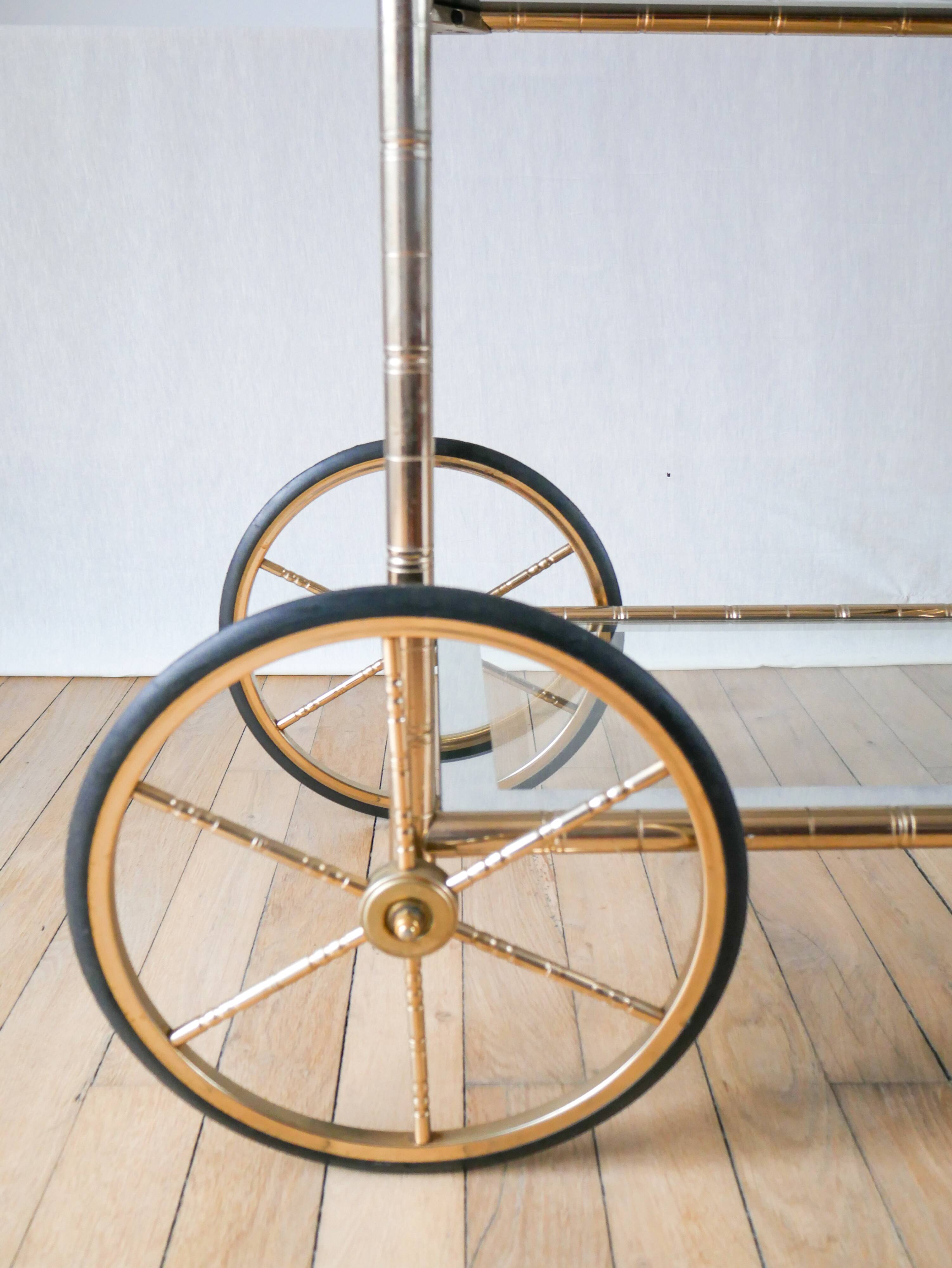 Serving table in gilded metal and glass with large wheels 1950