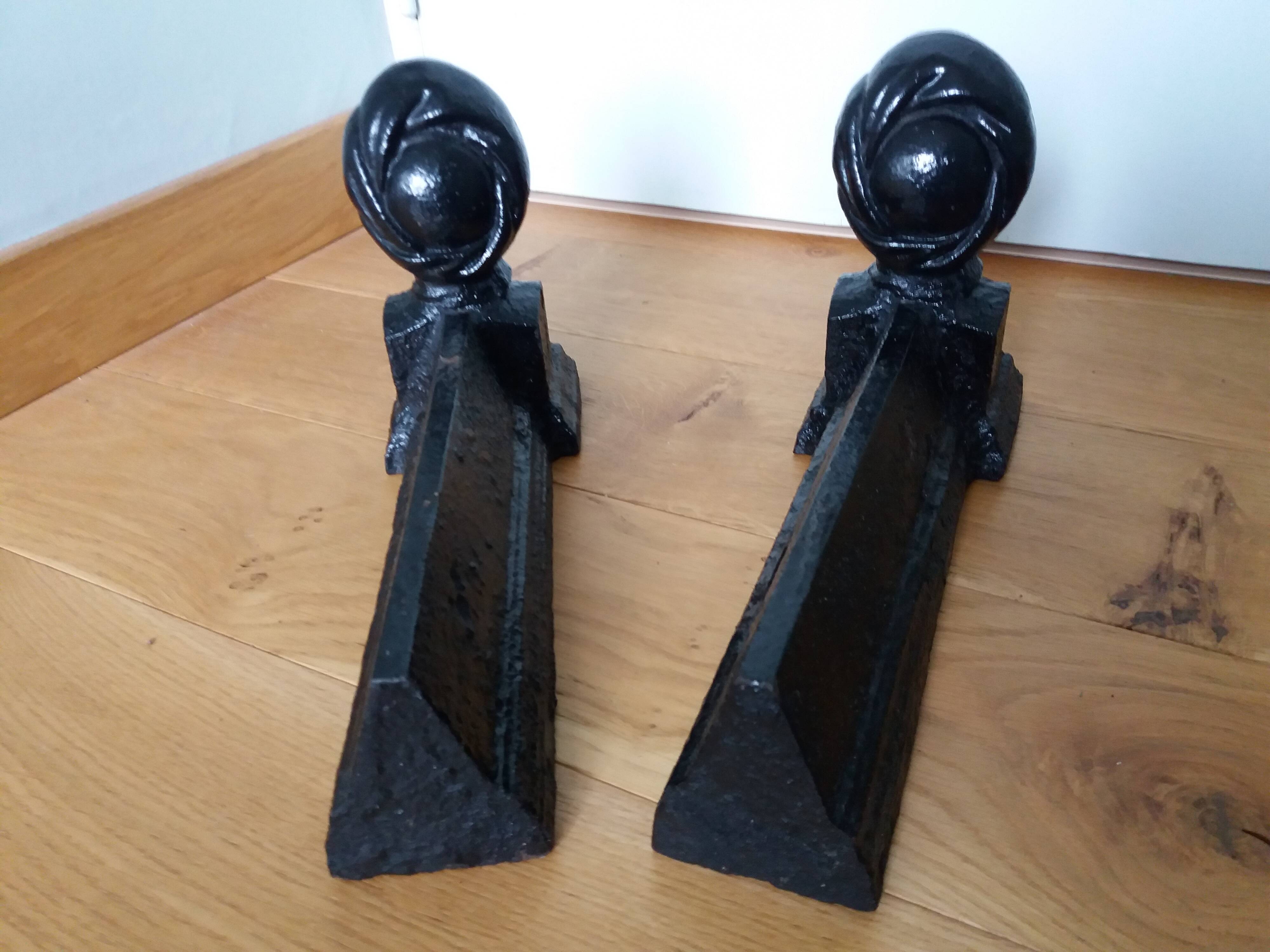 Cast iron andirons with character heads