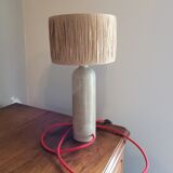 Sandstone lamp with raffia shade