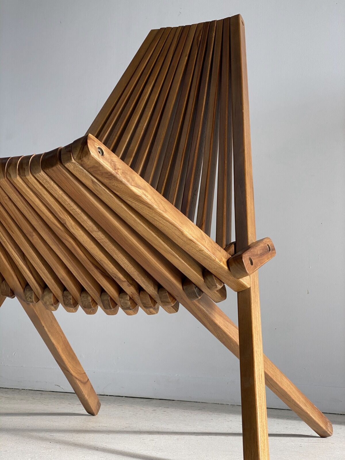 Foldable designer armchair in wooden slats