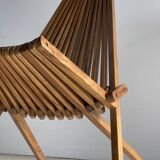 Foldable designer armchair in wooden slats