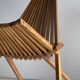 Foldable designer armchair in wooden slats