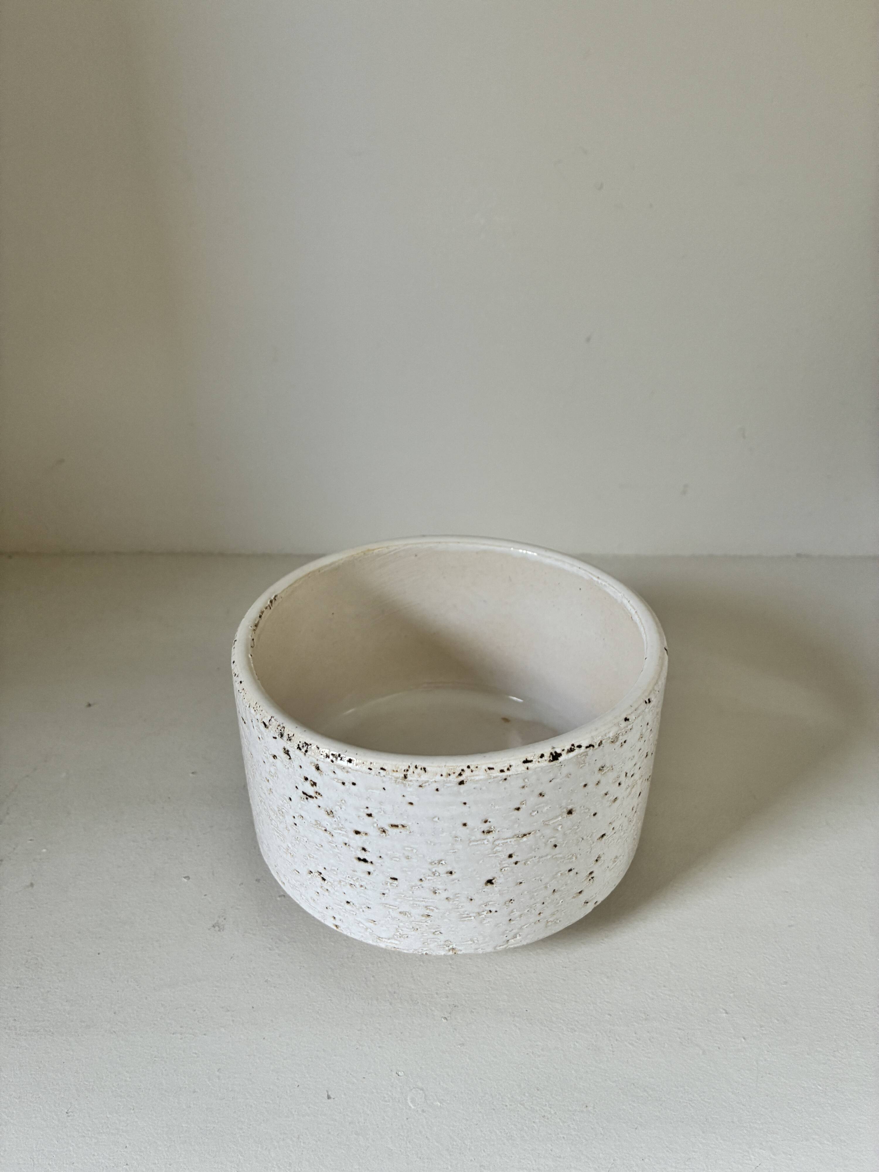 White ceramic vase with a textured effect.