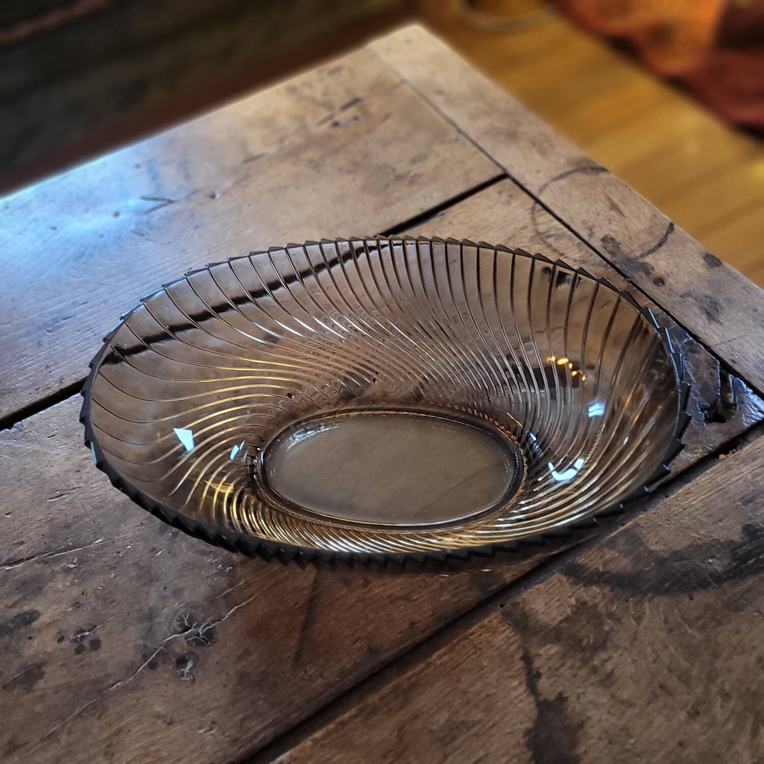 Smoked glass bowl with a radiating embossed pattern — 1970s