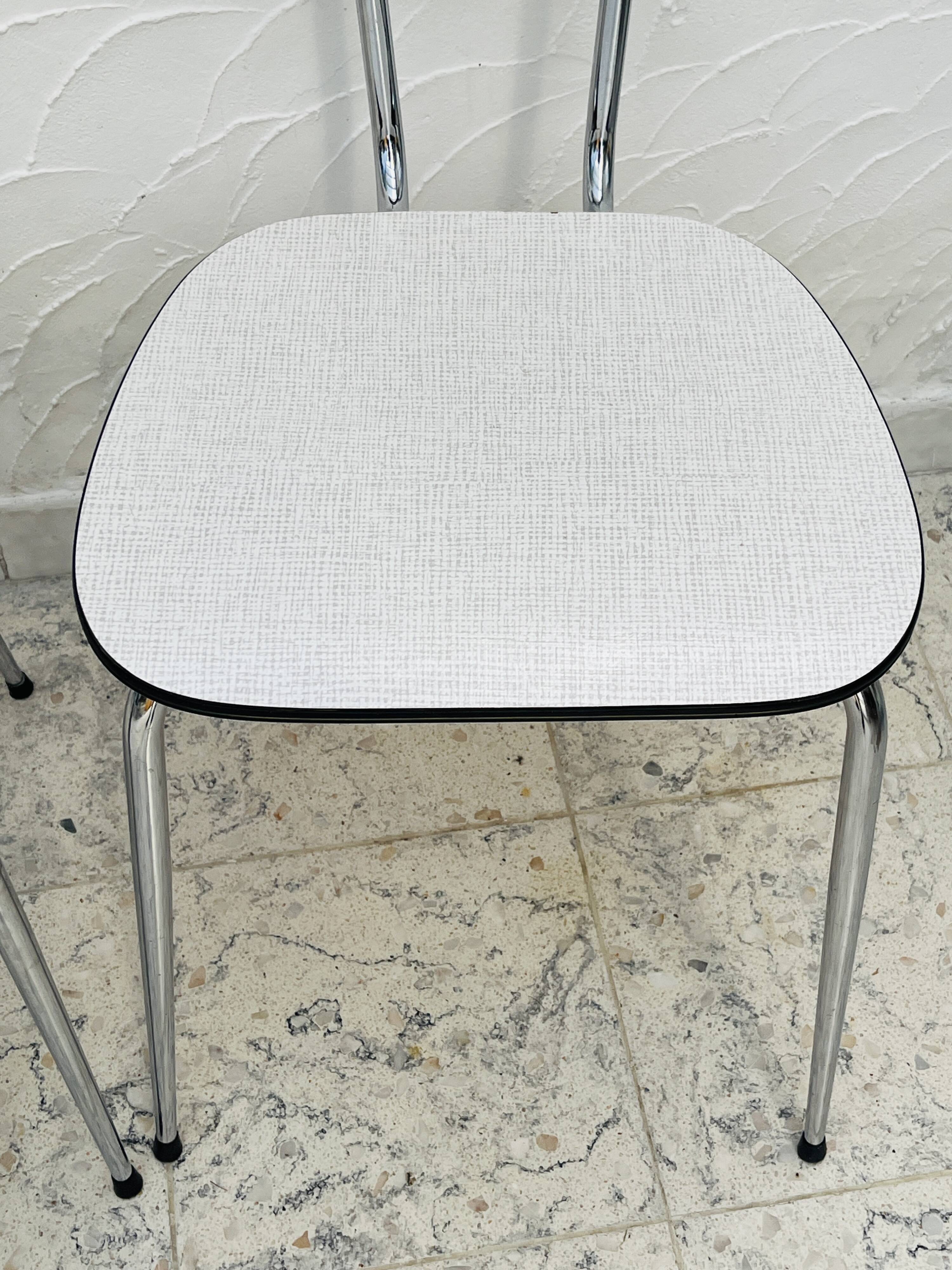 Set of two vintage grey Formica and chrome chairs.