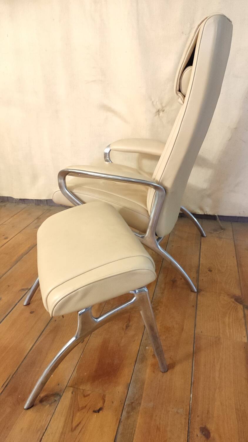 Beige leather armchair and footstool
