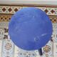Vintage tripod stool made of turned wood, painted blue.