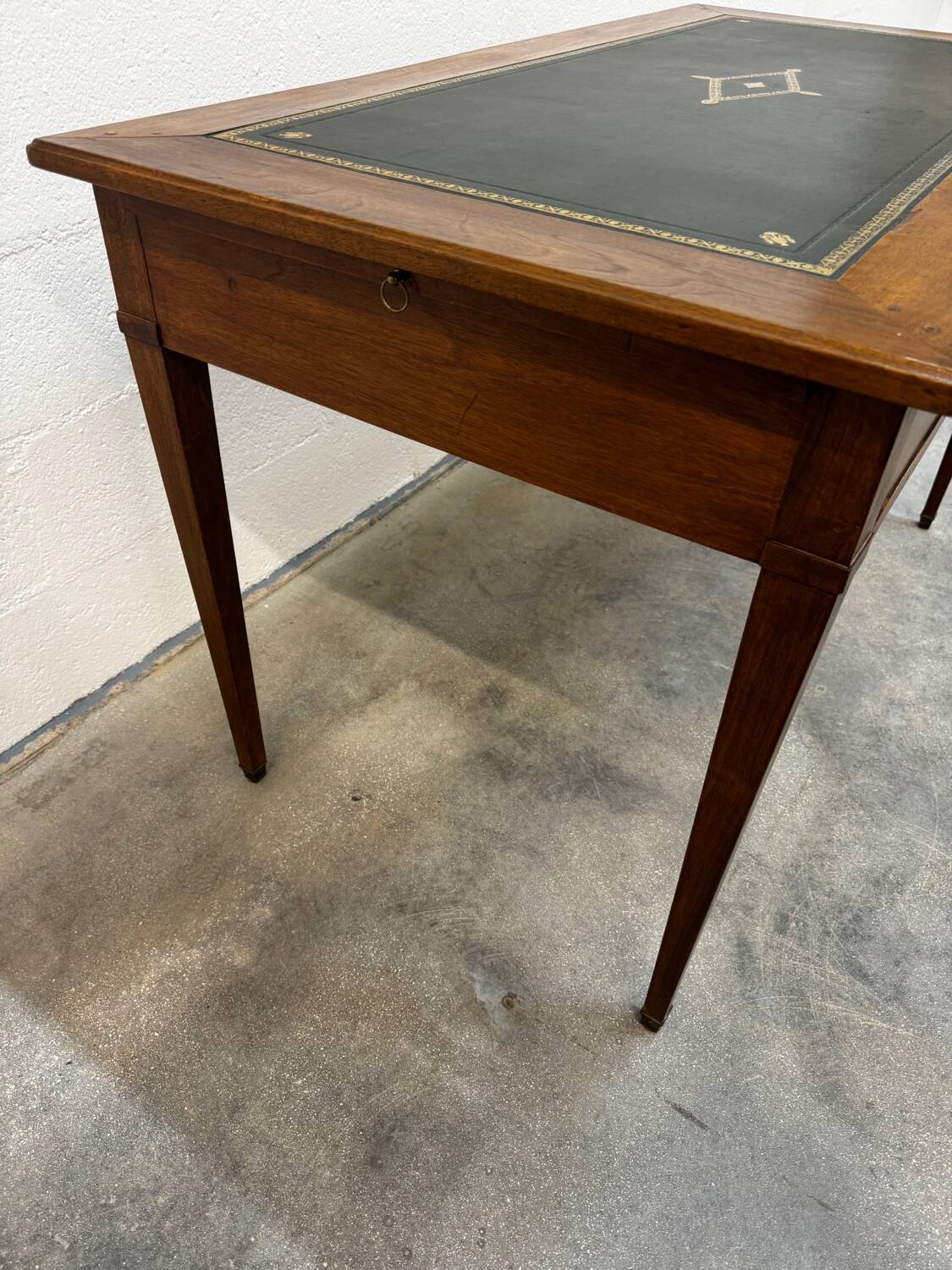 Louis XVI desk with green leather and shelves.