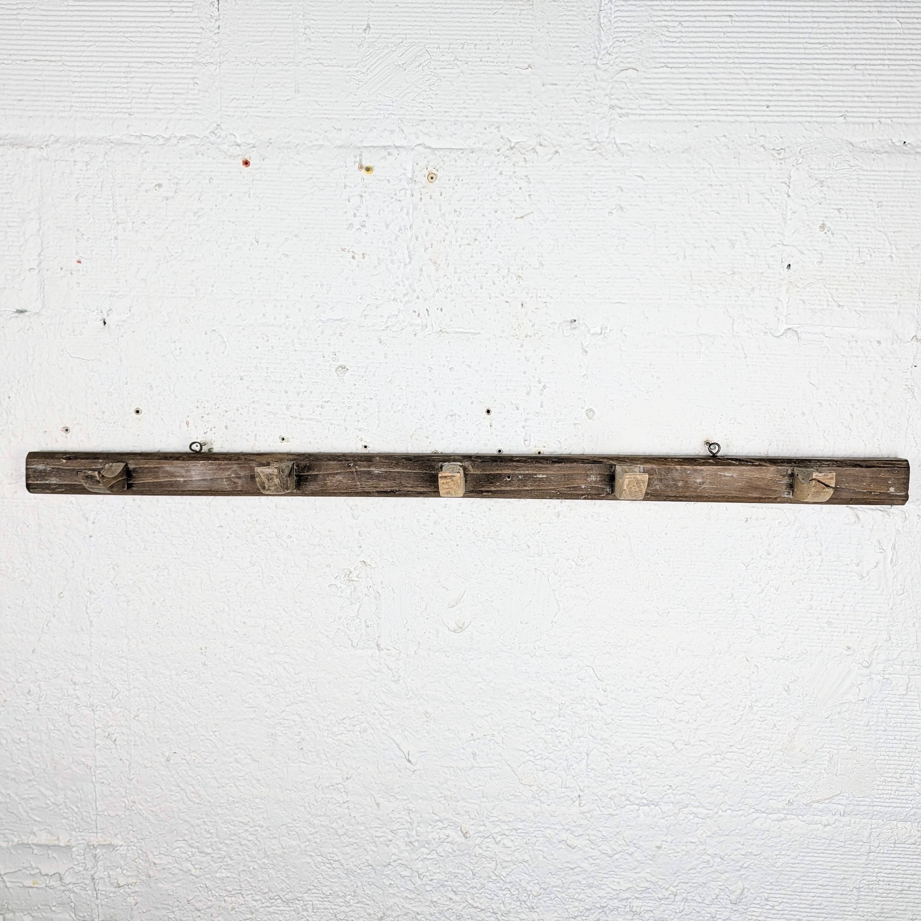 Handcrafted wall coat rack in raw wood