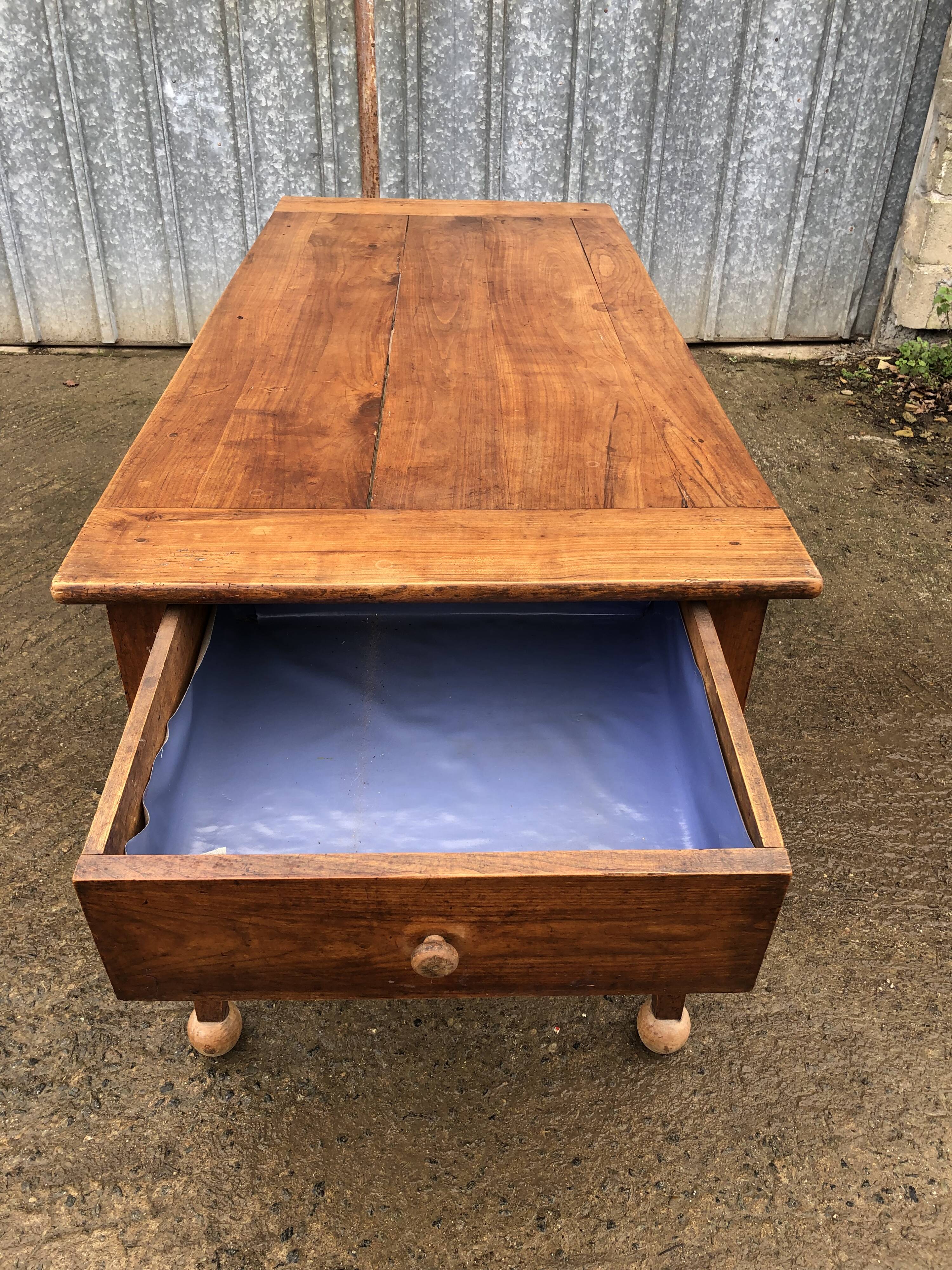 Antique solid cherry farmhouse table with 2 end drawers and 1 pull-out.