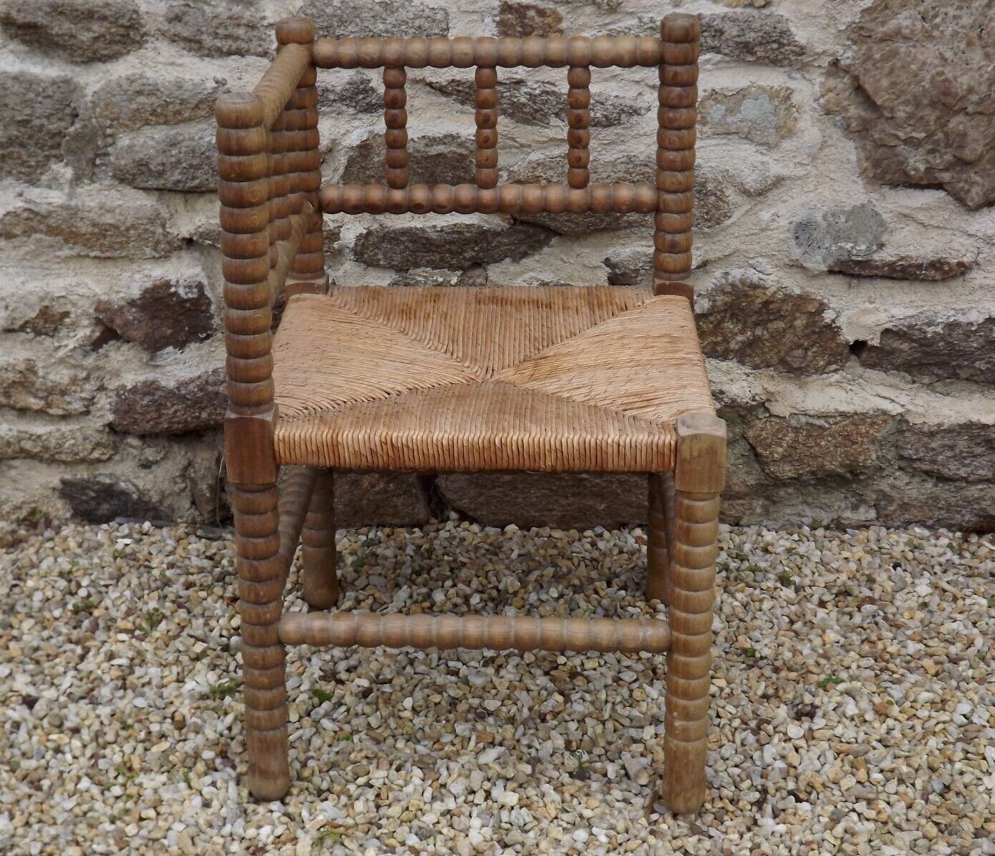 French antique turned wooden bobbin chair with rush seat