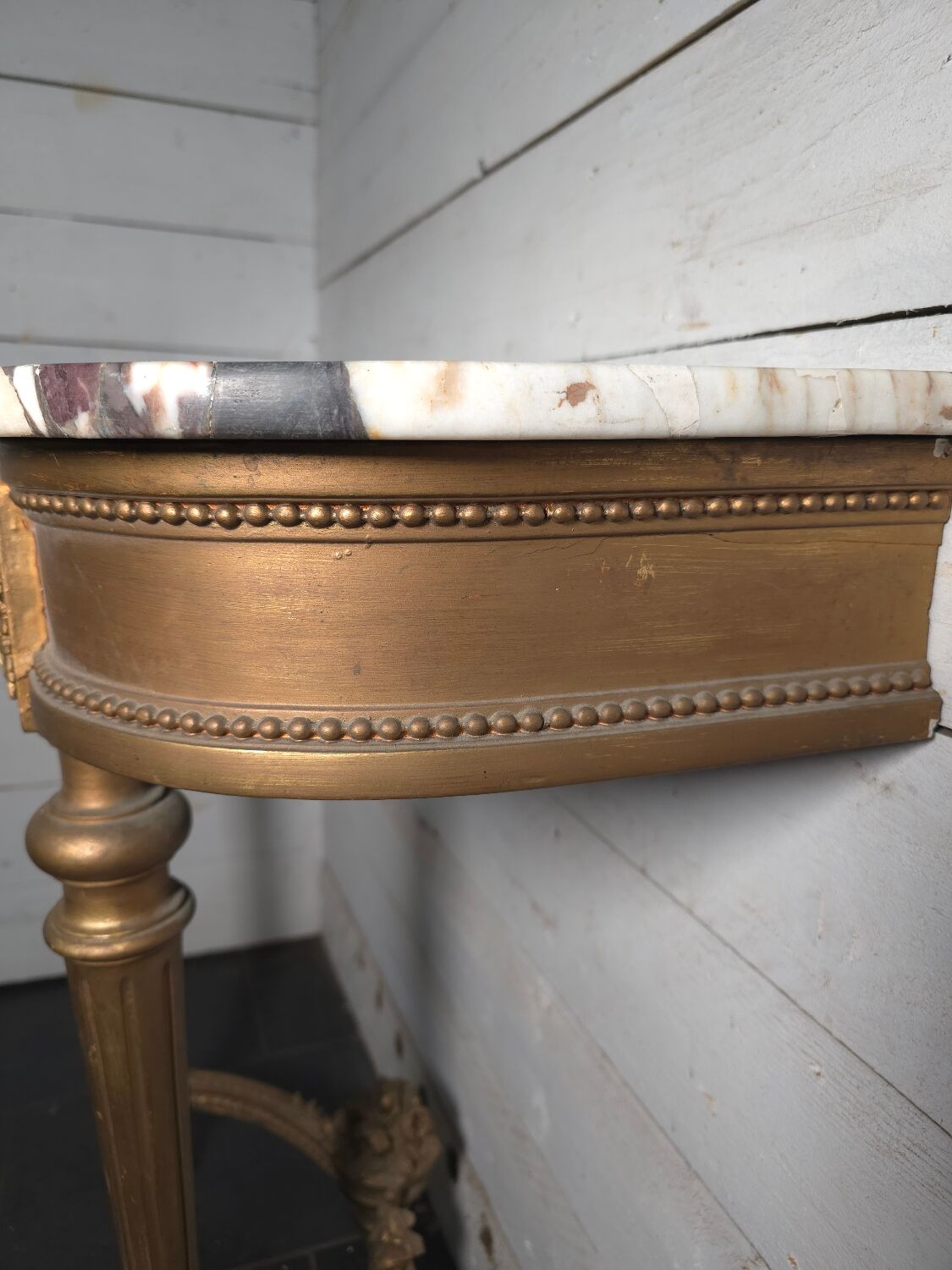 Louis XVI style console in gilded wood with a marble top.