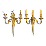 Pair of gilt bronze wall sconces with three lights in the Louis XVI style.