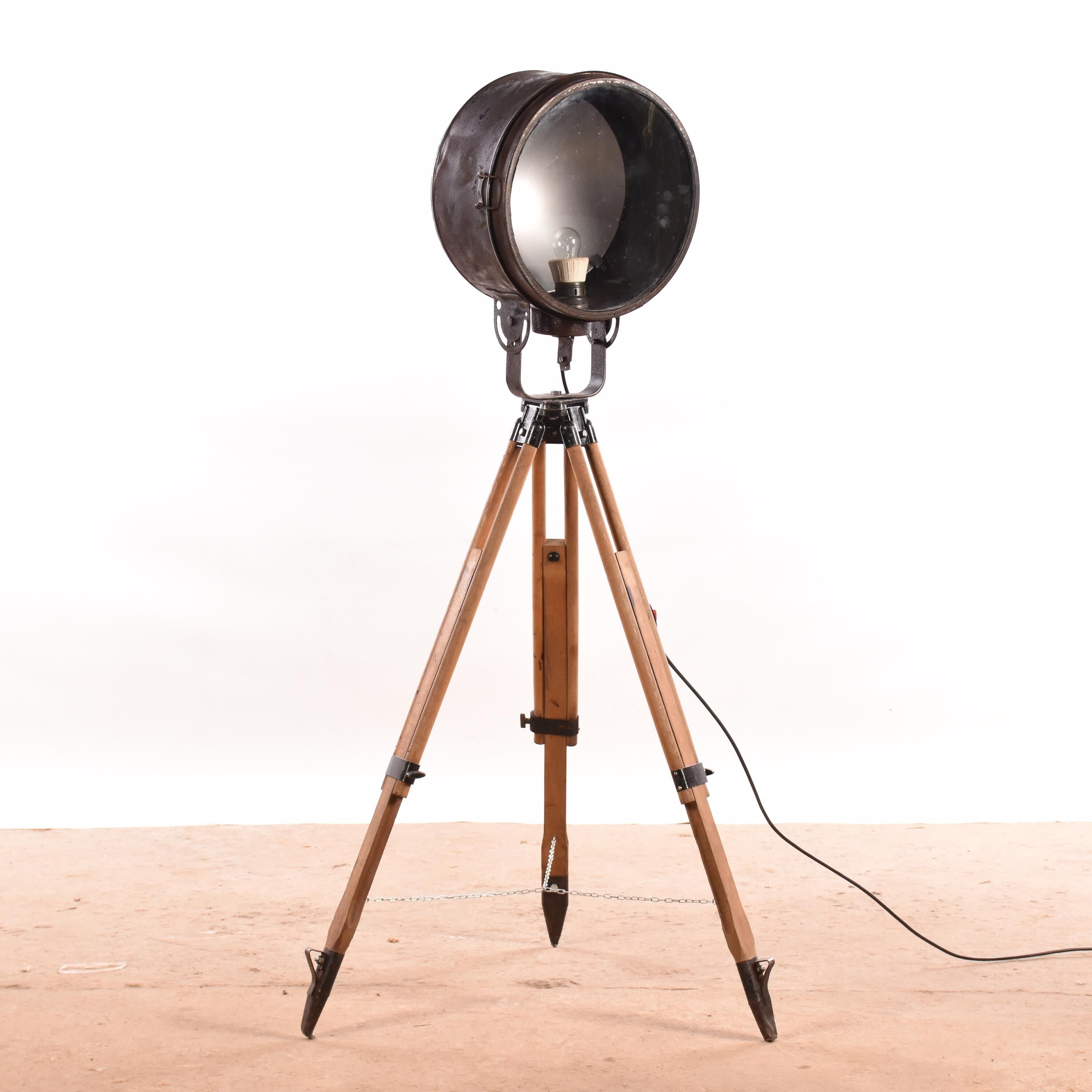 Old industrial spot on wooden tripod floor lamp